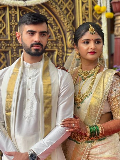 Another beautiful shot of the couple. The bride's makeup is subtle yet defining, perfect for her white and gold wedding saree.