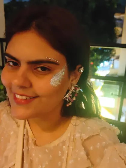 A smiling client showing off her glitter and gem combo. The added gems give the look an extra dimension of sparkle.