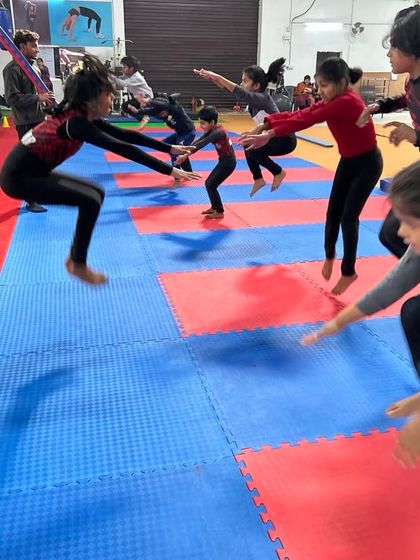 Plyometric jumps are great for developing explosive power for vault and tumbling. Here, a group of young gymnasts works on synchronized squat jumps.