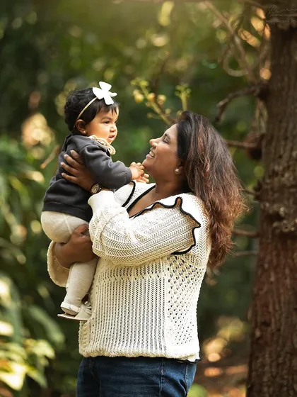 There's something magical about shooting outdoors in natural light. This sweet moment between a mother and her baby girl is filled with the warmth and beauty of nature.