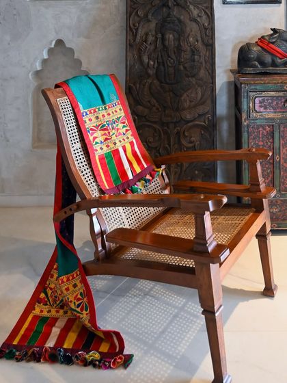 A different angle of the throw, showing how the reversible design allows for versatile styling. The bright, multi-colored stripes of the Rabari panel add a playful touch.