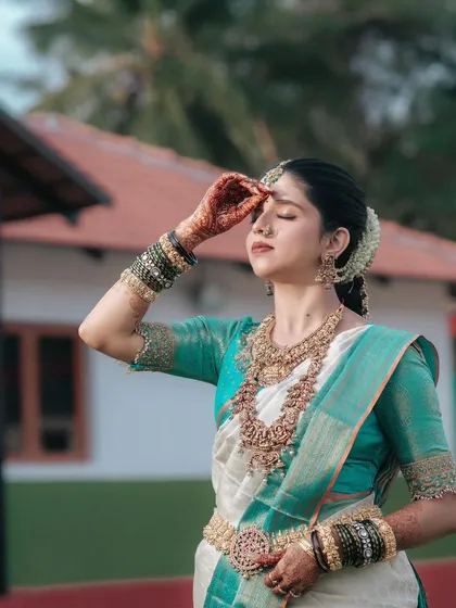 A serene and beautiful portrait of the bride, her eyes closed in a moment of quiet reflection amidst the wedding day festivities.