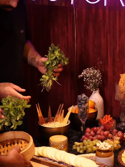 A behind-the-scenes moment of our team arranging fresh herbs on the grazing table. This shows the hands-on care and artistry that goes into every presentation.