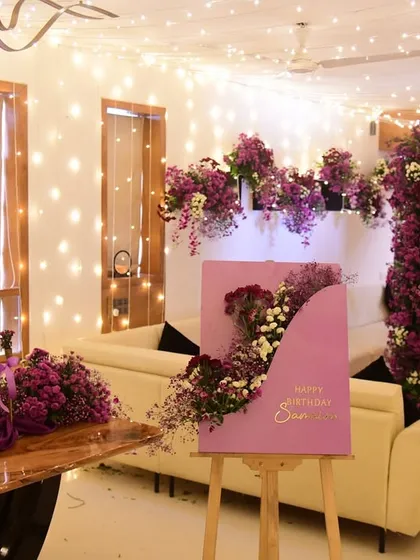 The complete party setup, ready for guests. The combination of lush florals and a canopy of fairy lights makes the space feel truly magical.
