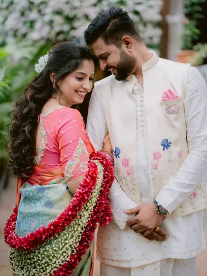 In a quiet moment together, Gayatri and Saurabh share a smile that speaks volumes. The soft light and natural setting complement the elegance of their traditional engagement attire.