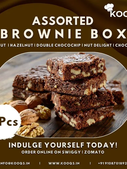 A close up of our Assorted Brownie Box, featuring a stack of rich, fudgy walnut brownies. Each box includes five different varieties, such as hazelnut and double chocochip, making it a perfect dessert to order online for yourself or as a gift.