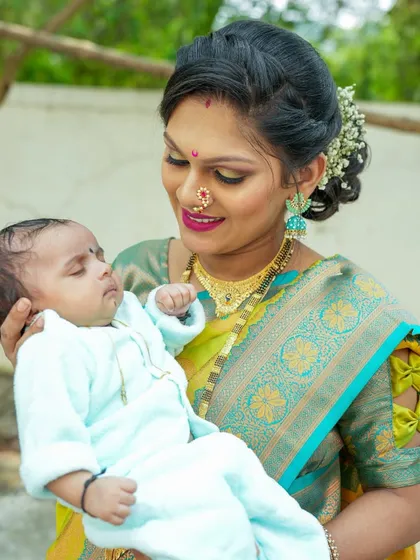 A mother's love. The tender way she holds her newborn speaks volumes in this beautiful, traditional portrait.
