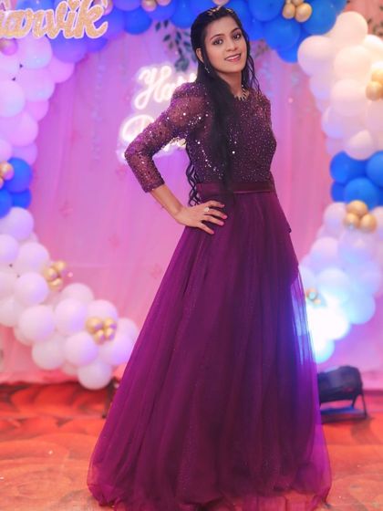A full-length shot of this elegant purple sequined gown, a perfect rental for a sophisticated birthday celebration.