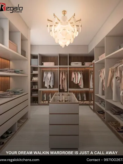 A bright and airy walk-in closet featuring white and wood-grain finishes. The central island provides drawer storage, while open shelving and hanging spaces are illuminated by integrated lighting.