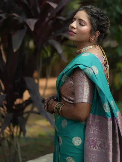 A beautiful three-quarter profile of the bride, her makeup looking perfect against the natural backdrop.