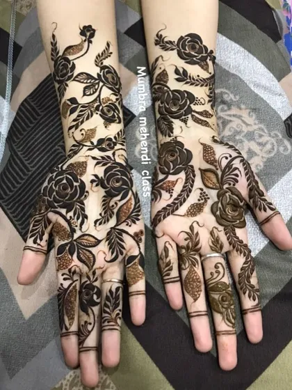 A beautiful example of a rose vine design covering both hands and arms. This is a favorite for many clients.