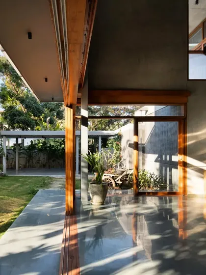 The morning sun casts long shadows across the polished concrete verandah, illustrating the daily play of light that we choreograph in our designs.