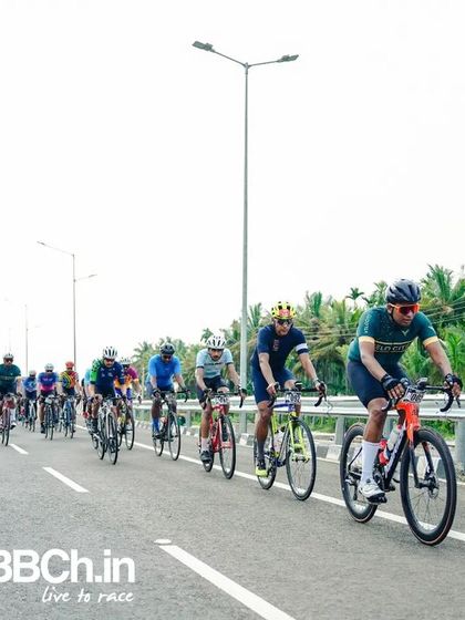 The peloton, a colorful and dynamic sight, races down the highway.