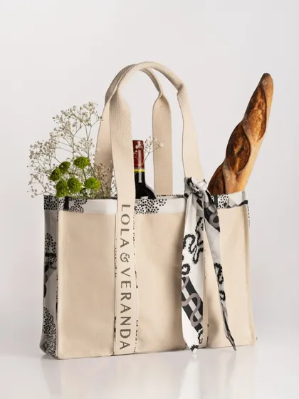 An accessory is more than an object; it's part of a lifestyle. For this Lola & Veranda tote, I styled it for a chic picnic, filled with a fresh baguette, a bottle of wine, and flowers. This setup instantly tells a story of sophisticated leisure.