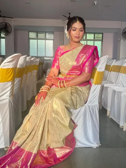 A full-length seated portrait, capturing the grace and elegance of the complete traditional look.