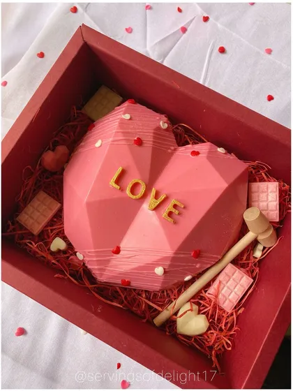 Smash your way to a sweet surprise! My piñata cakes are a huge hit. This one is a geometric heart shell that you break with a hammer to reveal treats inside.