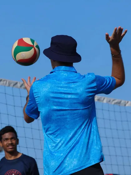 Tossing the ball to demonstrate the arc of a perfect set. I believe in showing, not just telling.