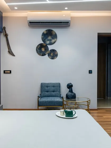 Every corner is considered. This seating area offers a quiet spot to relax, with curated art pieces that add a personal touch to the room's cool, contemporary vibe.
