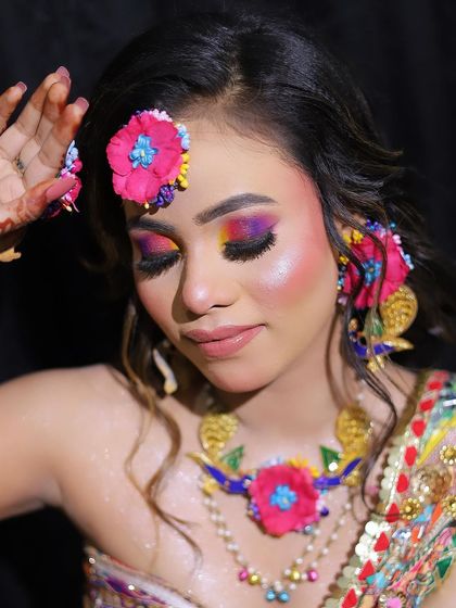 A detailed shot of the floral necklace and the colorful makeup. This look is perfect for a bride who wants to stand out and have fun with her pre-wedding style.