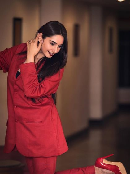 A powerful portrait of Ragini Dwivedi for her brand ambassadorship announcement. The red blazer and direct gaze convey confidence and professionalism, perfect for corporate and commercial campaigns.