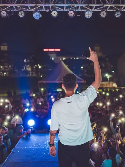 There's no feeling like connecting with thousands of people at once. This moment, with a sea of lights from the crowd, shows the shared energy and memorable atmosphere I strive to build at every large-scale event.