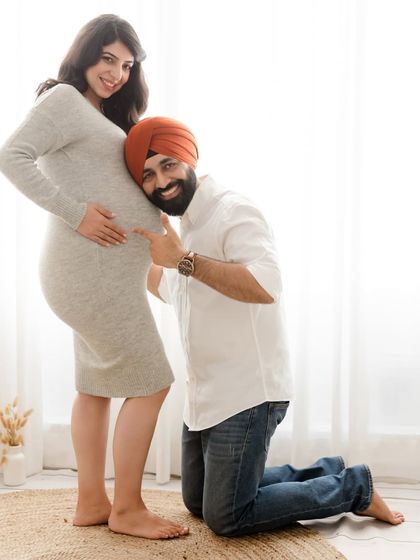 A playful and sweet maternity photo where the dad-to-be listens to the baby bump. This shot is a favorite for capturing the couple's happy anticipation.