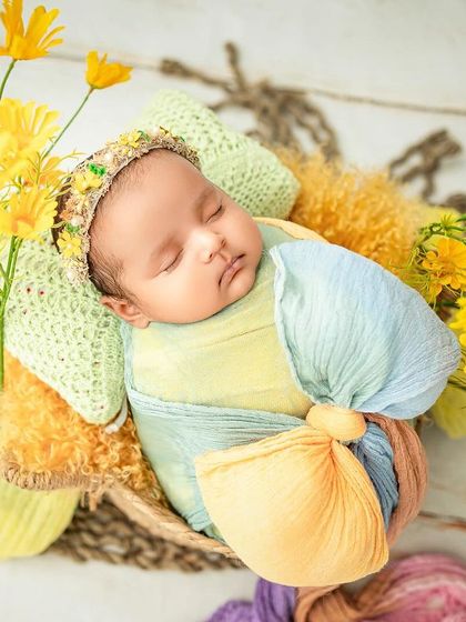 A little butterfly resting among the flowers. I love using bright, happy colors like yellow to create a joyful and vibrant newborn portrait.