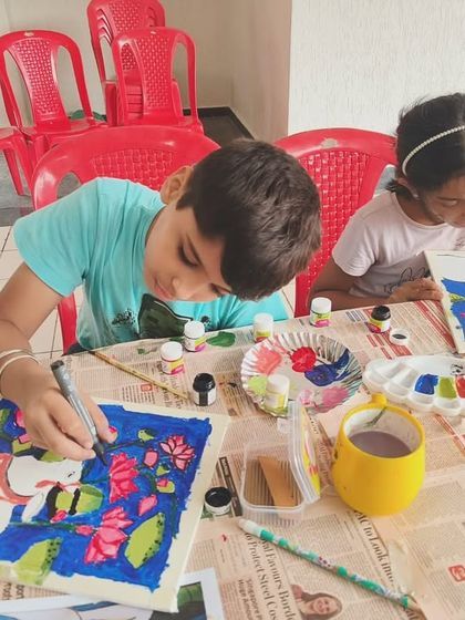 Young students focused on their Pichwai paintings. Our workshops are designed for all ages, allowing kids and adults to learn and create together in a supportive setting.