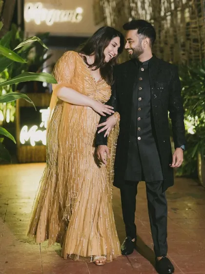 Juhi and Jay share a laugh during their engagement party. Dressed in stunning coordinated outfits, their happiness and connection are palpable in this walking shot.