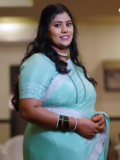A soft glam look for a wedding guest in a mint green saree. The makeup features a berry lip and defined eyes.