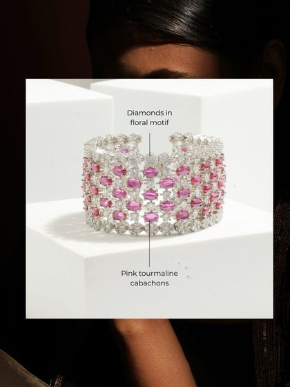 The Pink Dew Drop Bracelet is a true statement piece. This wide cuff features a graceful floral motif with pink tourmaline cabochons and sparkling diamonds.
