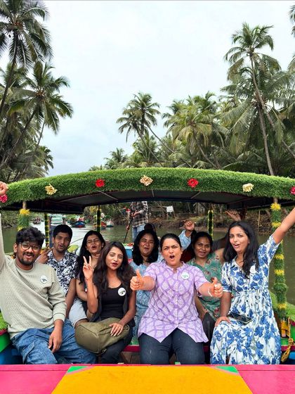 A cheerful group enjoying a decorated boat ride through the Honnavara backwaters. It's a relaxing and scenic part of my coastal escape package.