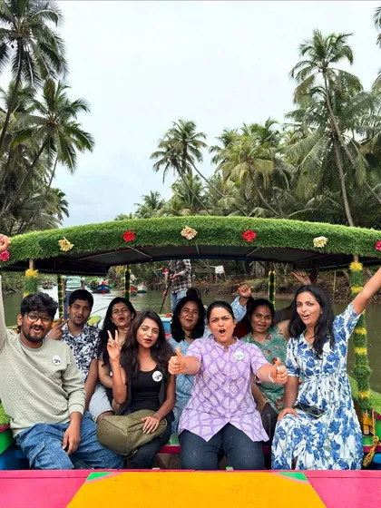 All smiles on a decorated boat in the Honnavar backwaters. The vibrant boat and happy faces capture the fun spirit of our trips.