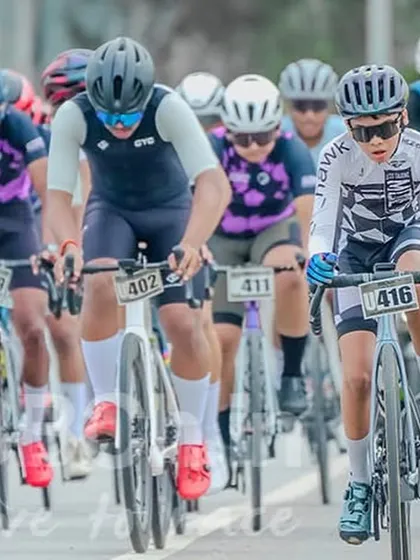 A focused group of young cyclists in the peloton. The experience gained in these races is invaluable for their development as competitive athletes.
