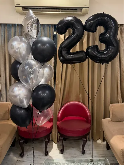 Cheers to 23! We designed this elevated birthday balloon arrangement with a sleek black and silver theme, featuring giant number balloons and a matching bouquet for a sophisticated celebration.
