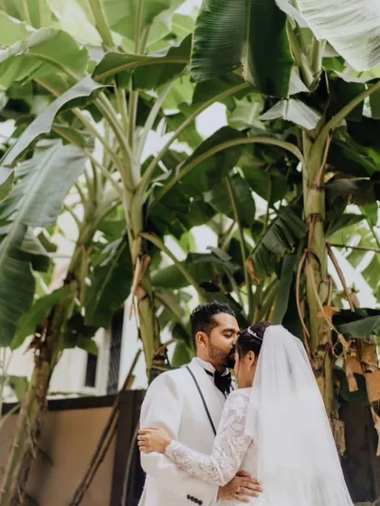 A tender forehead kiss amidst lush greenery. A beautiful, calm moment for Jeffrey and Delilah after saying "I do."