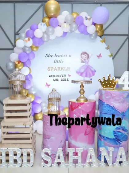 "She leaves a little sparkle wherever she goes." This Sofia the First theme includes a custom backdrop with a lovely quote, butterfly details, and a purple and white balloon arch.