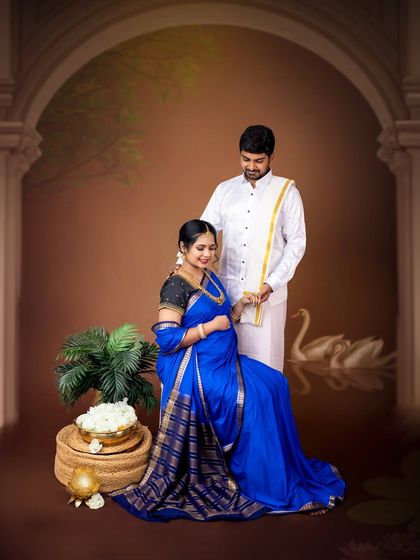 A beautiful scene of the couple in a traditional setting. The husband-to-be gently places flowers in his wife's hair, a classic gesture of love and care.