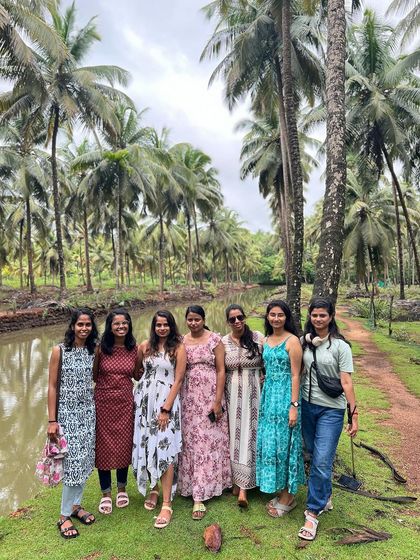 A group of girls posing in a coconut grove.