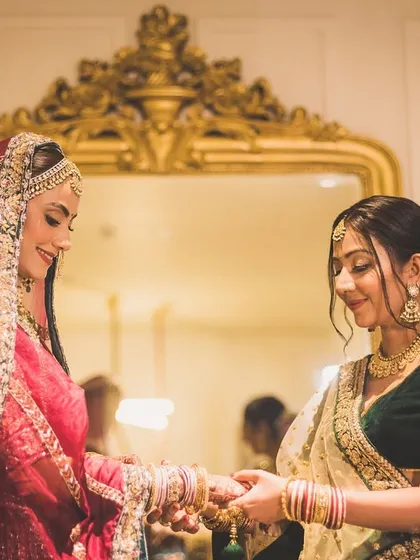 A quiet moment between sisters or close friends as the bride gets ready. These are the bonds that make a wedding day so special.