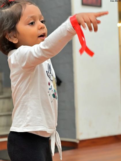A young dancer pointing with determination. We nurture passion and focus from a young age.