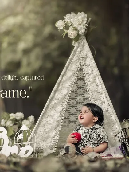 Pure delight captured in a frame. This smiling baby in our outdoor teepee setup is the picture of happiness.