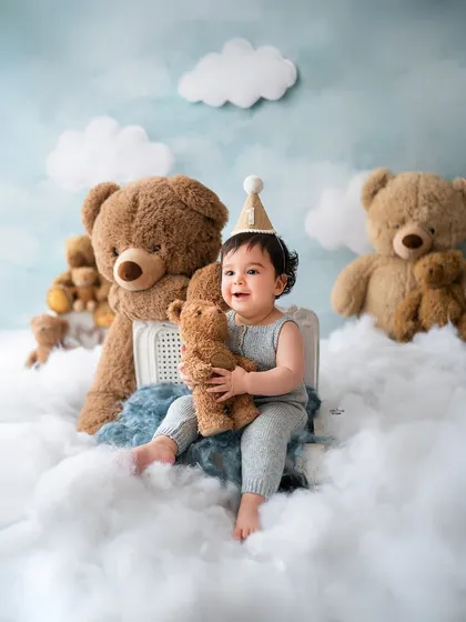 This little one is on cloud nine with his giant teddy bear. A dreamy and whimsical setup for a baby boy's photoshoot.