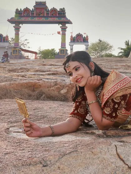 A closer portrait that captures a gentle expression. The temple arch in the background frames the shot and reinforces the traditional theme of the photoshoot.
