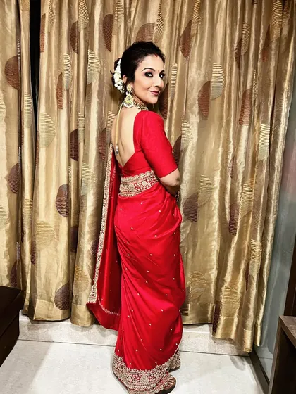 A side view of the gajra bun, showing how it is elegantly placed to complement the client's profile and her beautiful jewelry.