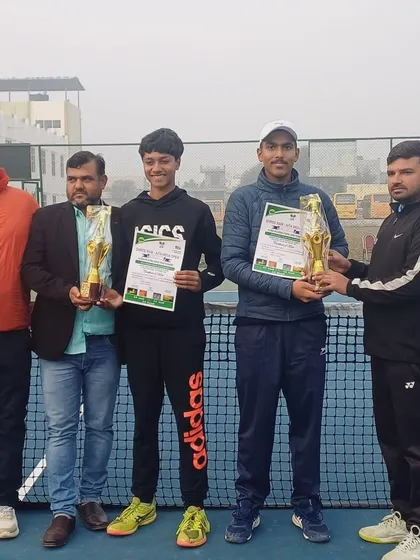 Navya Yadav and his partner receiving their trophies for the Boys Under-16 Doubles win at the Asian U-16 Tournament.