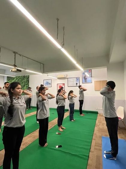 Another shot of the standing warm-ups at the SA Consultant corporate yoga class.