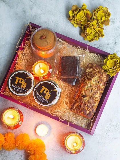 The Bliss Hamper is our curated box of happiness for Diwali. It includes a variety of our bestsellers like a dessert jar, a savory snack jar, coffee almond cookies, a teacake, brownies, and our healthy dry fruit ladoos.