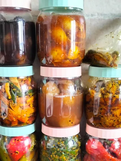 A colourful lineup of my homemade pickles, each jar filled with a different taste of home. You can see the variety, from the dark sweet lemon pickle to the bright red chilli and golden mixed vegetable achars.