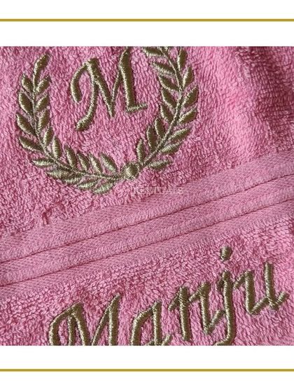 For this special birthday gift, I did custom embroidery on a soft pink towel. It features the initial 'M' inside a laurel wreath and the name 'Manju' below it, adding a touch of luxury and personalization.